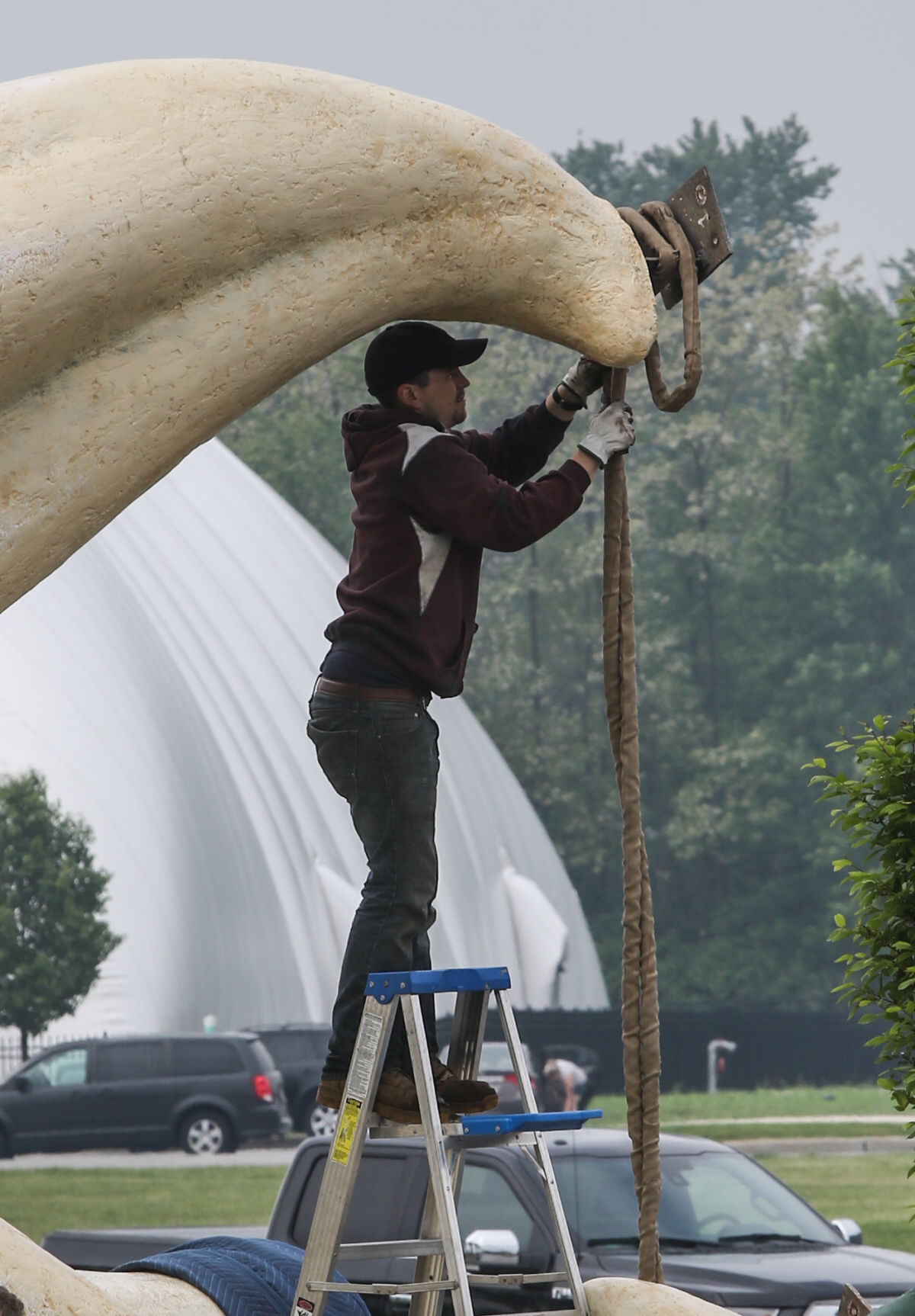Artist Seward Johnson's "The Tooth" is implanted at the Crown Point Sportsplex